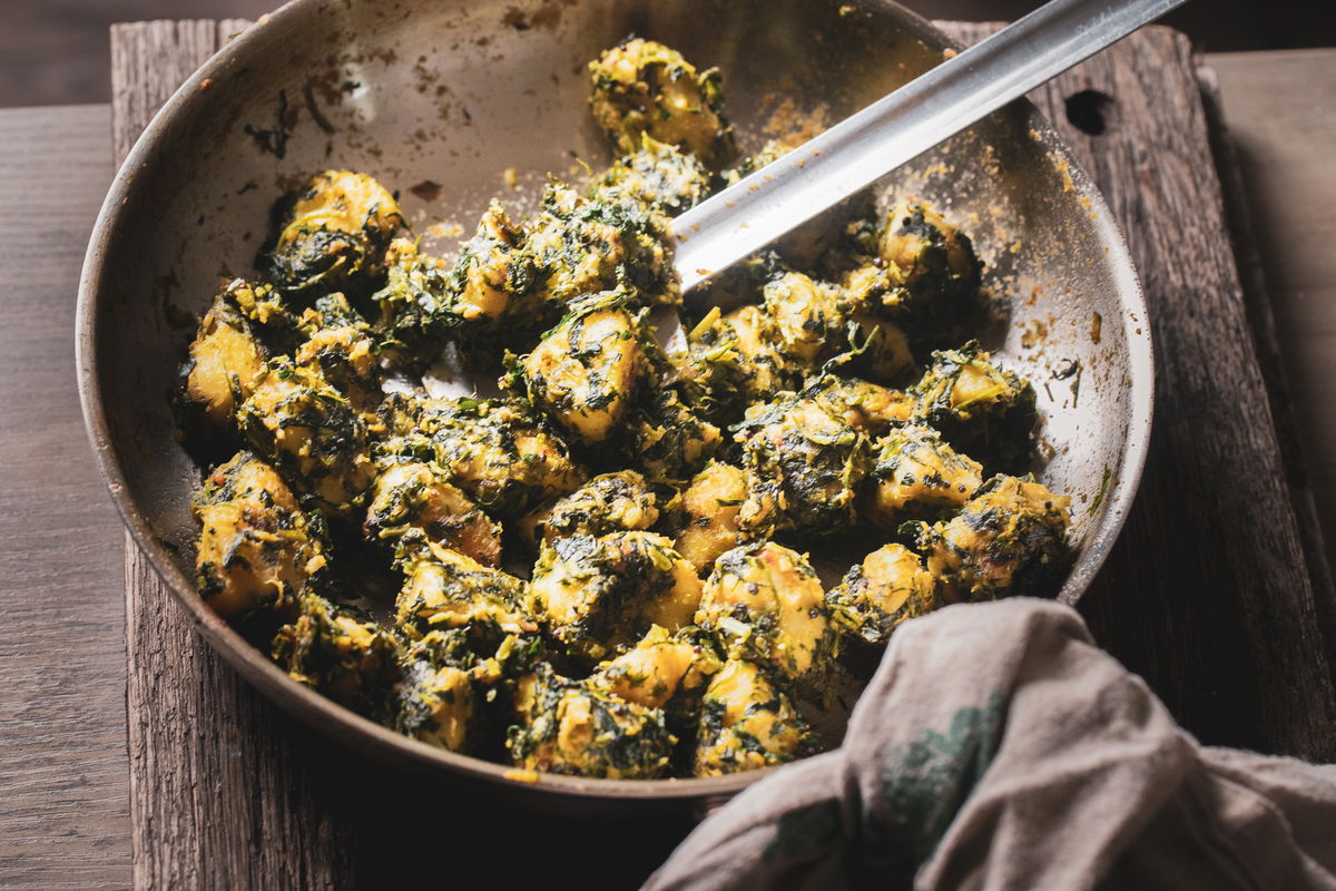 Wide shot of sweet potato shaak in pan