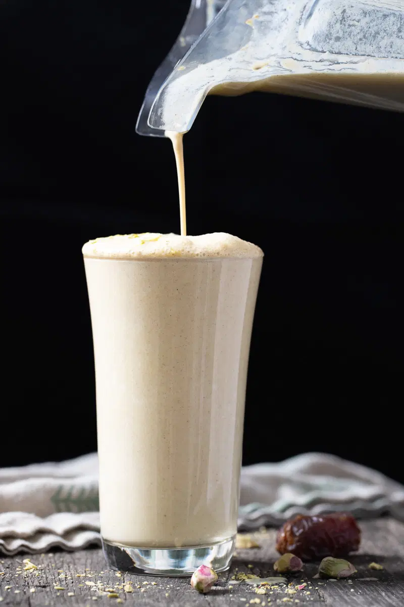 Pouring the date milk from the blender