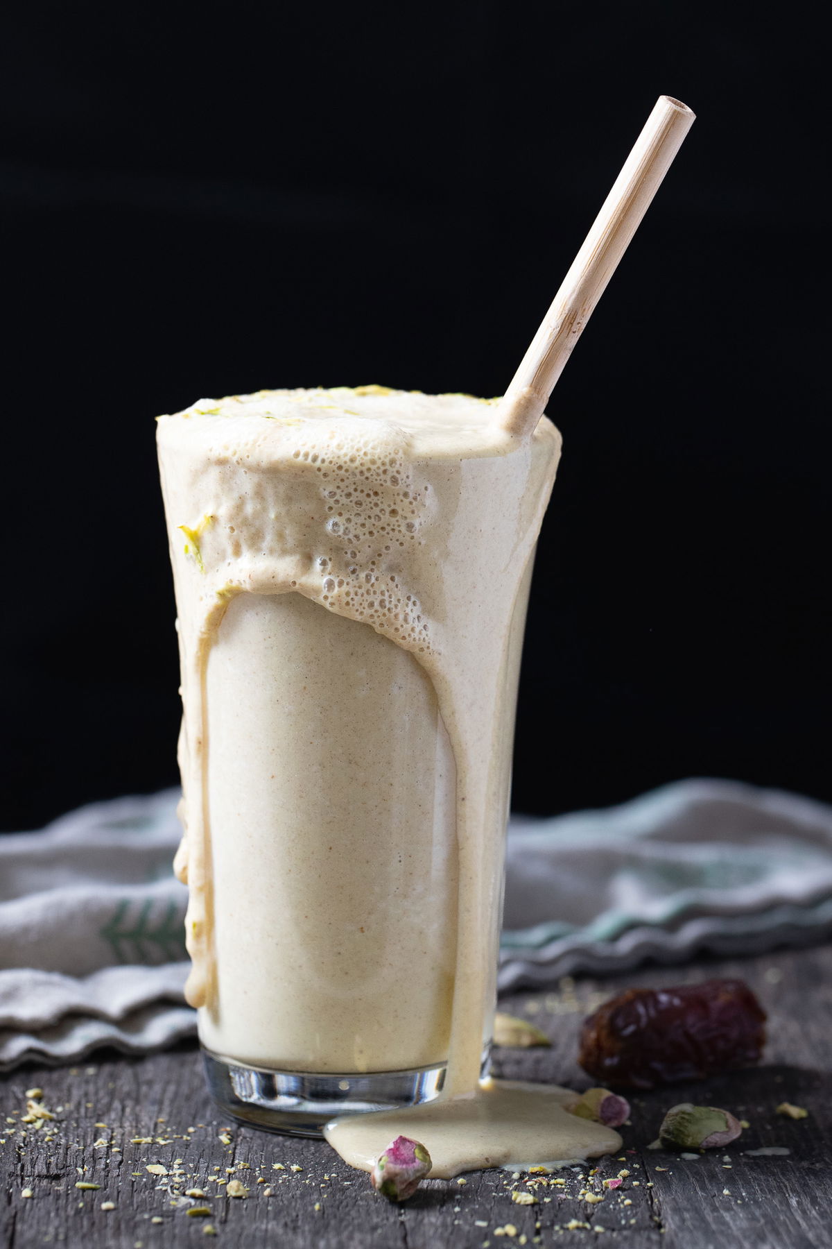 Date milk spilling out over the glass