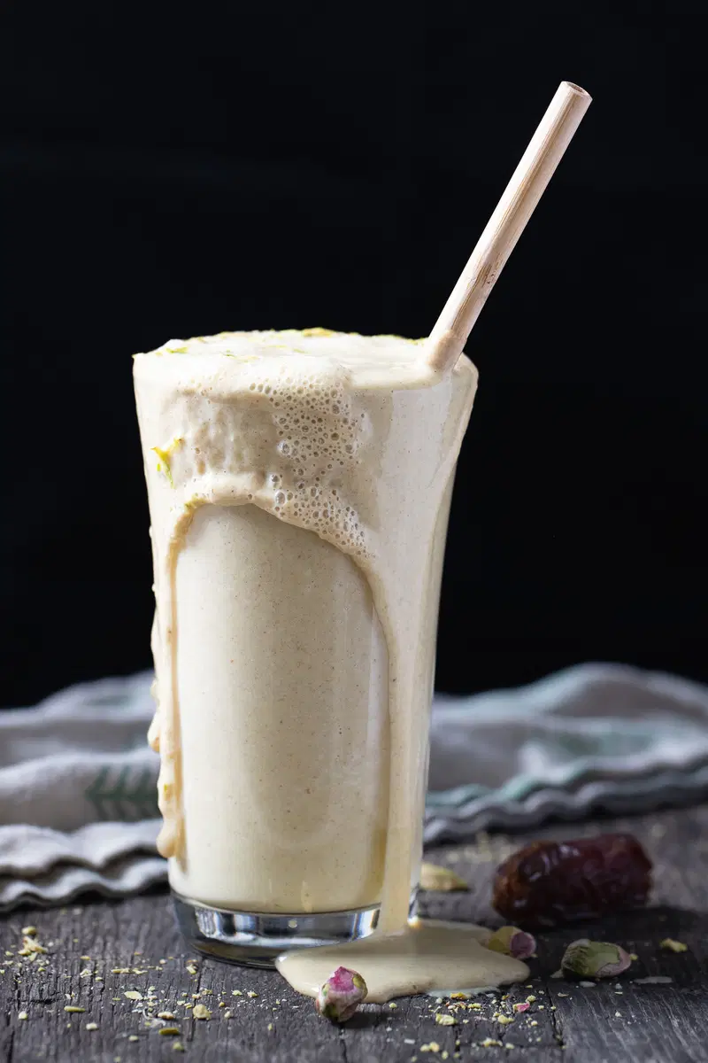 Date milk spilling out over the glass