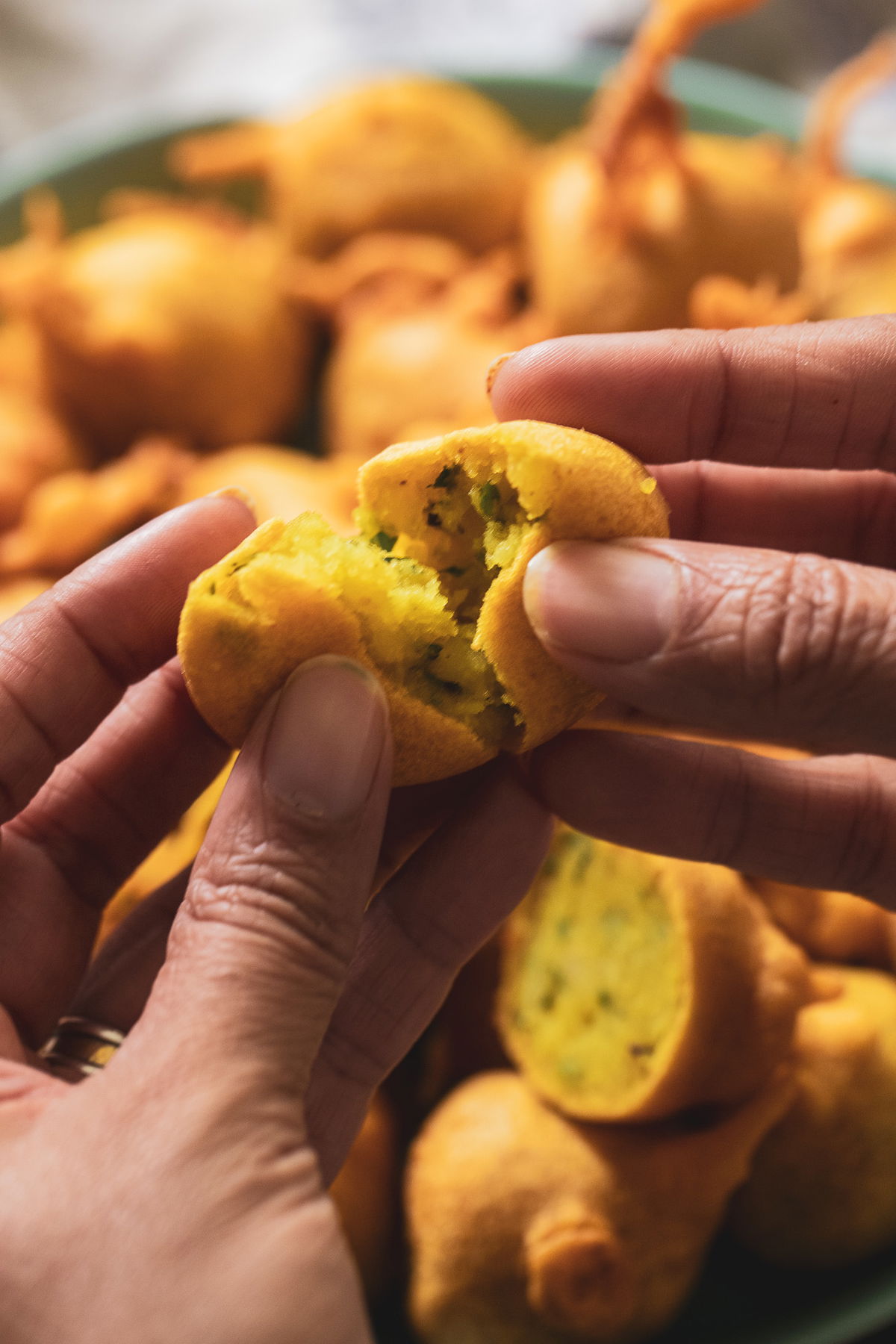 Opening a batata vada.