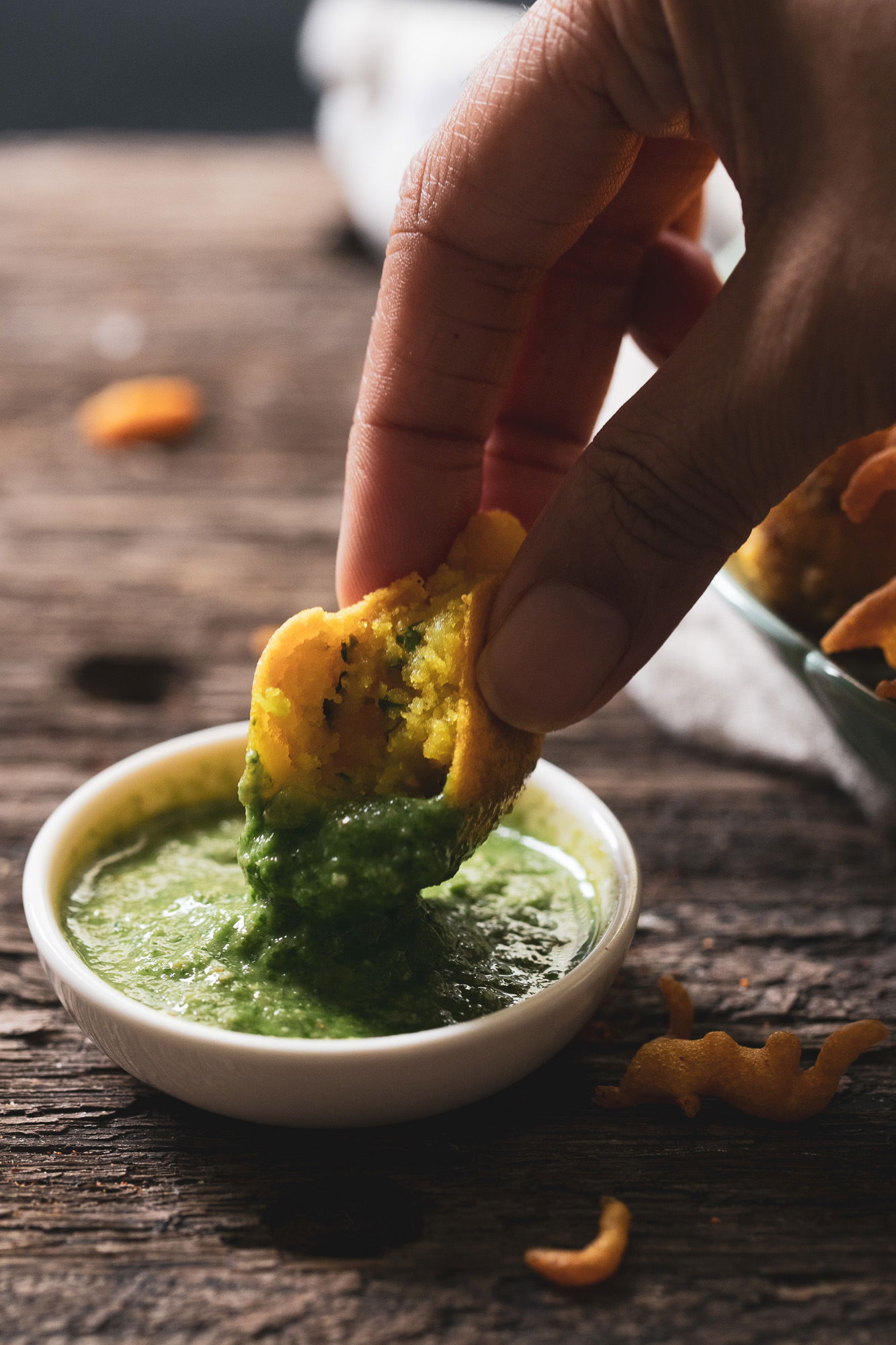 Batata vada in green chutney.