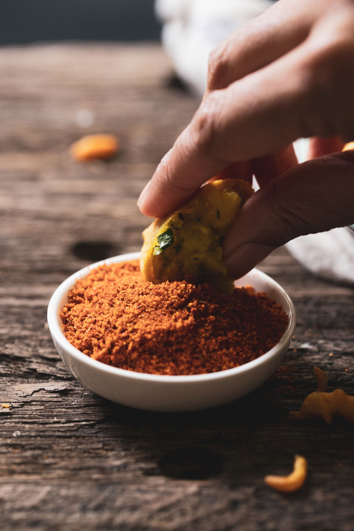 Dipping batata vada in lasan chutney.