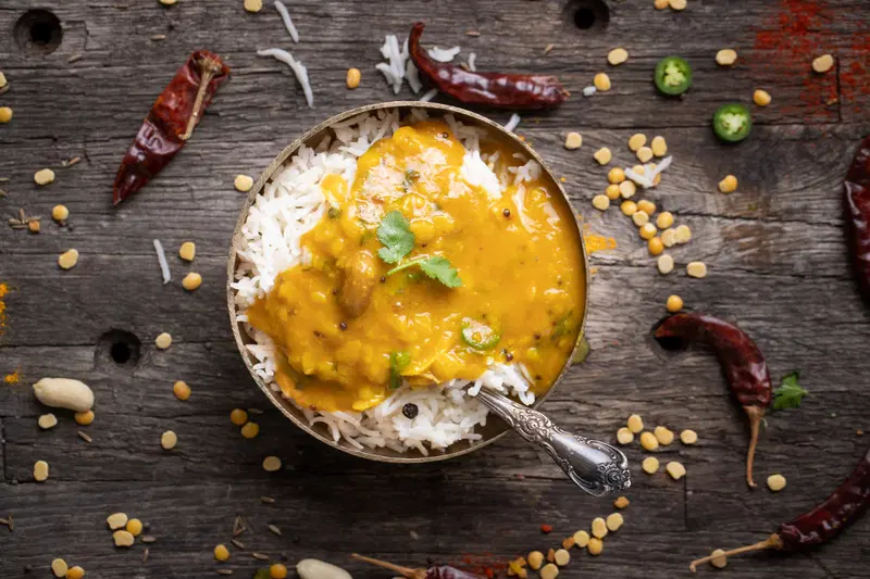 A bowl of Gujarati dal over rice.