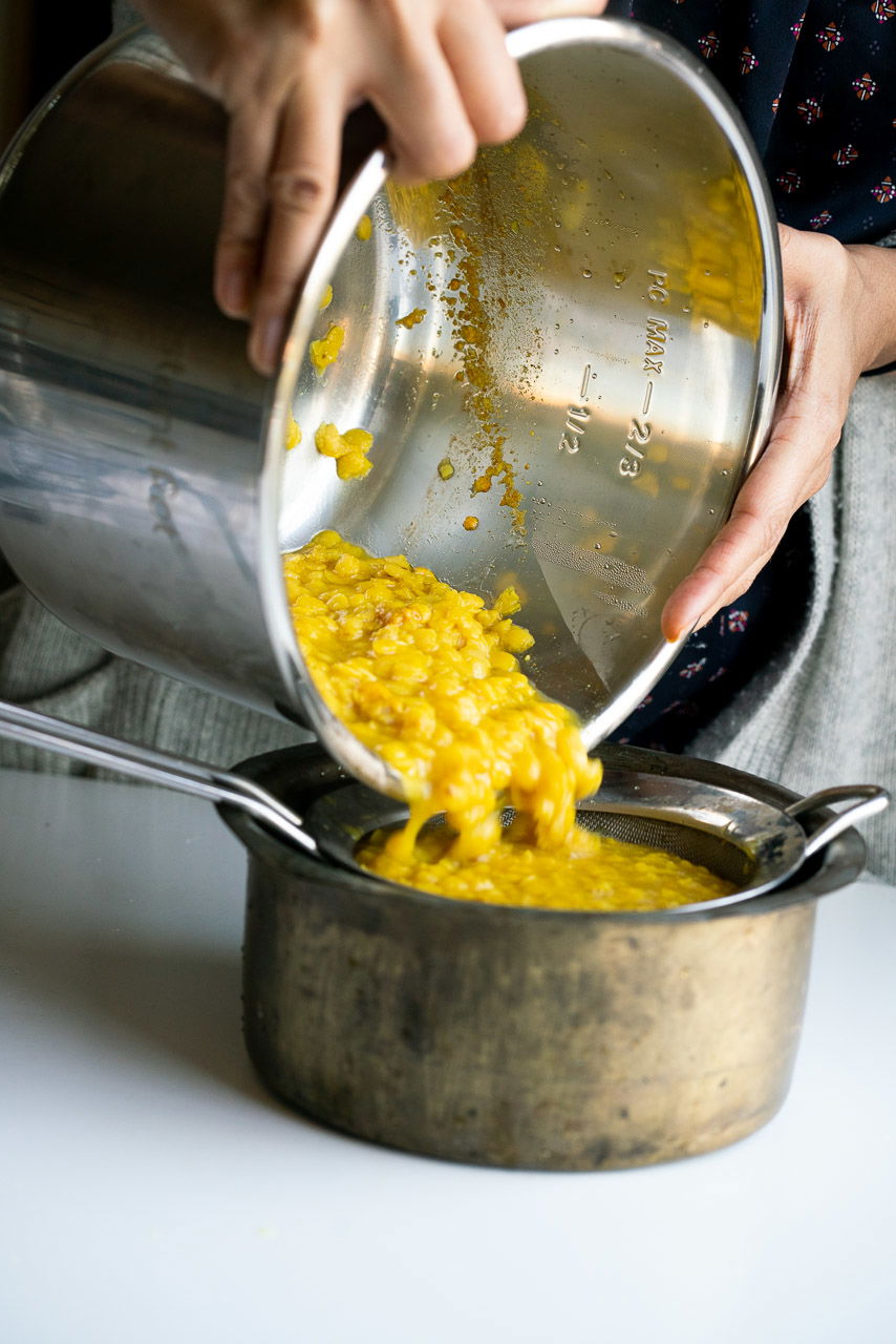 Straining out the broth to make Osaman and Lachko Dal