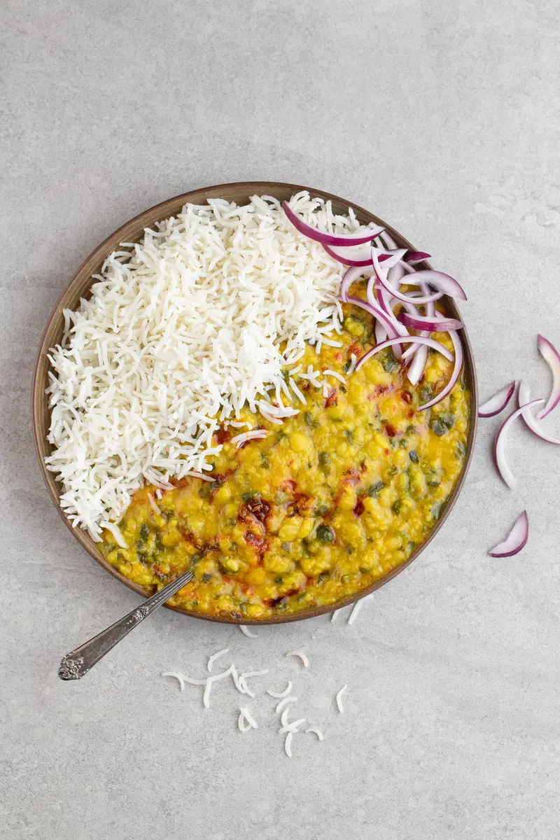 A plate of dal saag with basmati rice