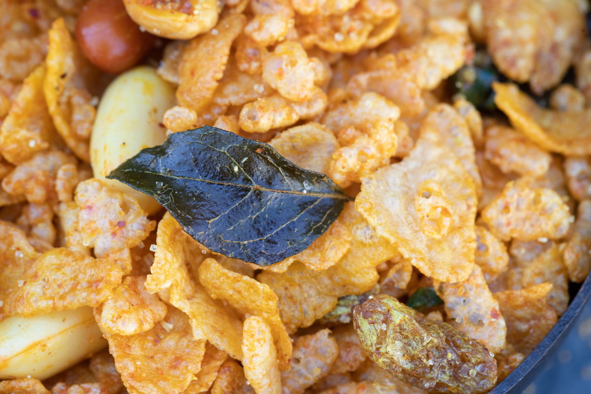 Close up of a curry leaf on chevdo