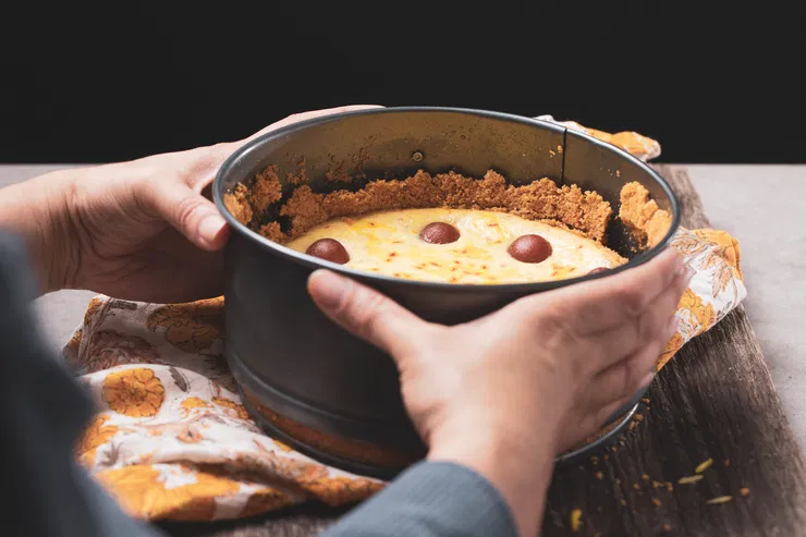 Removing the cheesecake from the pan.
