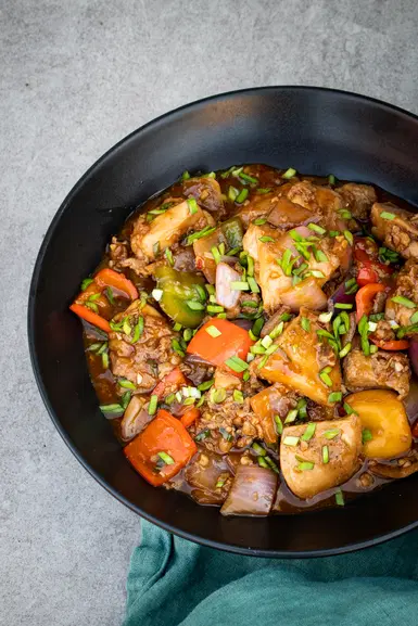 Chicken manchurian in a black bowl