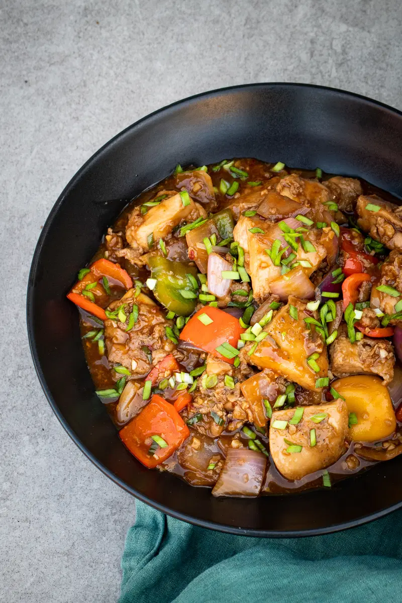 Chicken manchurian in a black bowl