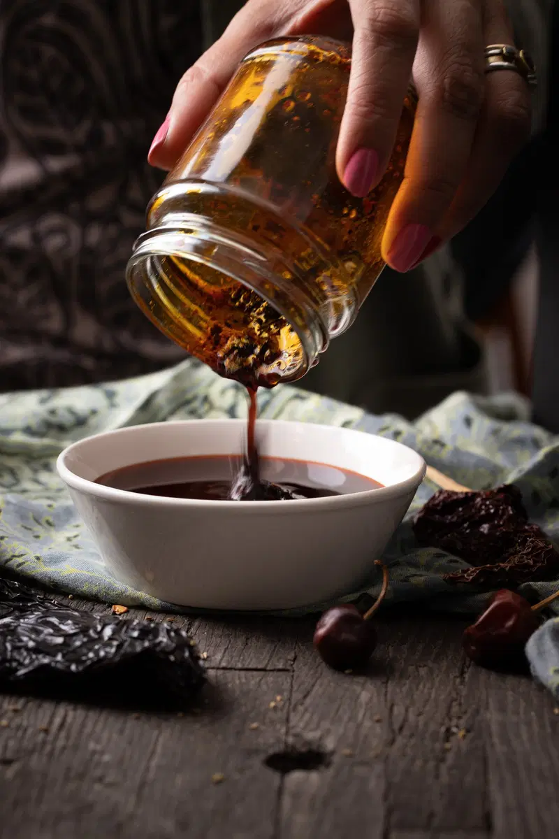 Pouring chili oil into a bowl