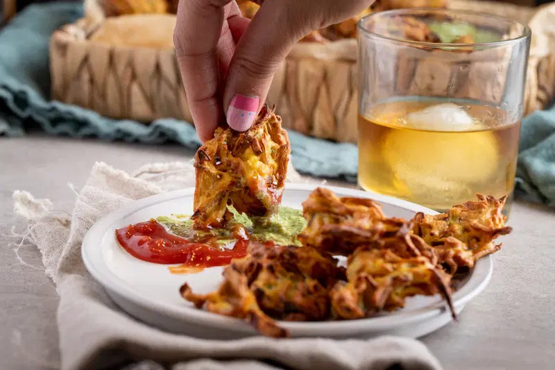 Onion pakora served with whiskey and chutney