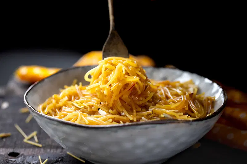 Bowl of meethi sev on a black background