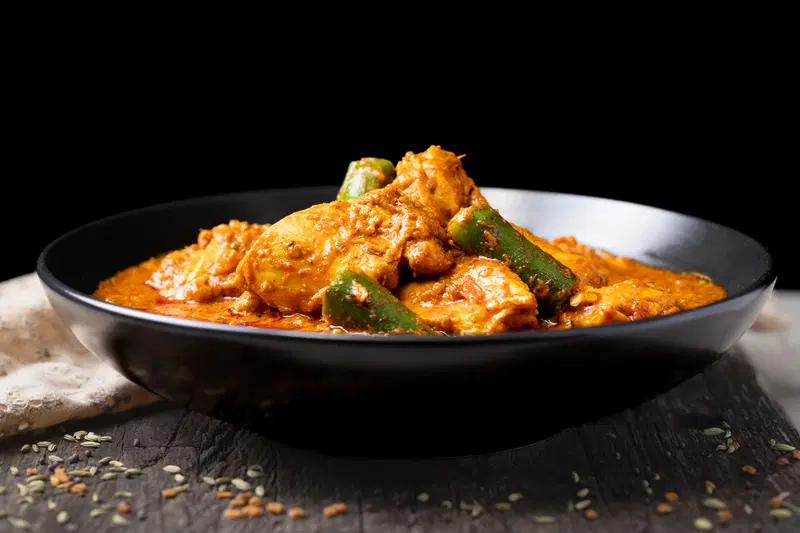 Bowl of achari chicken