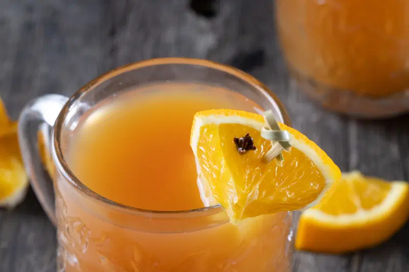 Garnish hot gin punch with orange and clove