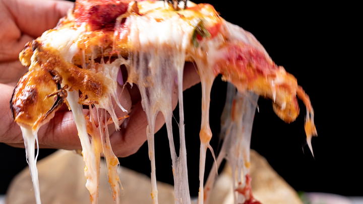 Cheese pull of paneer tikka pizza