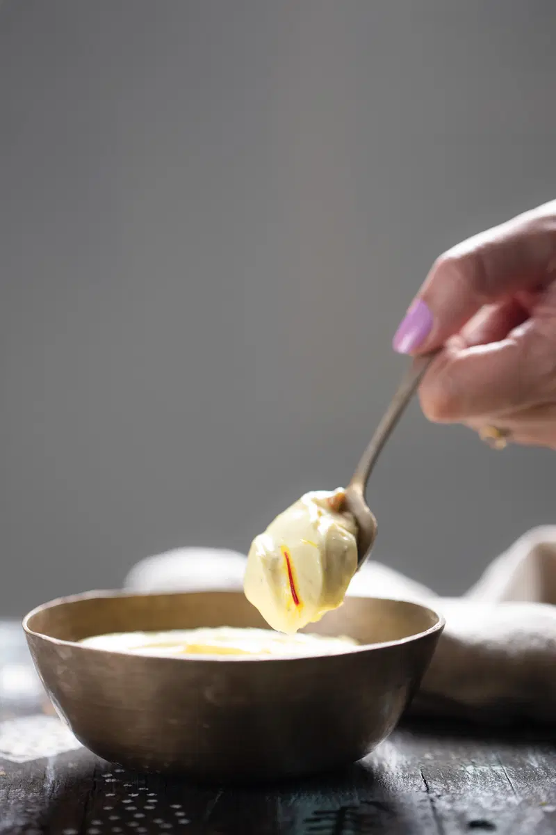 Spooning shrikhand from a bowl