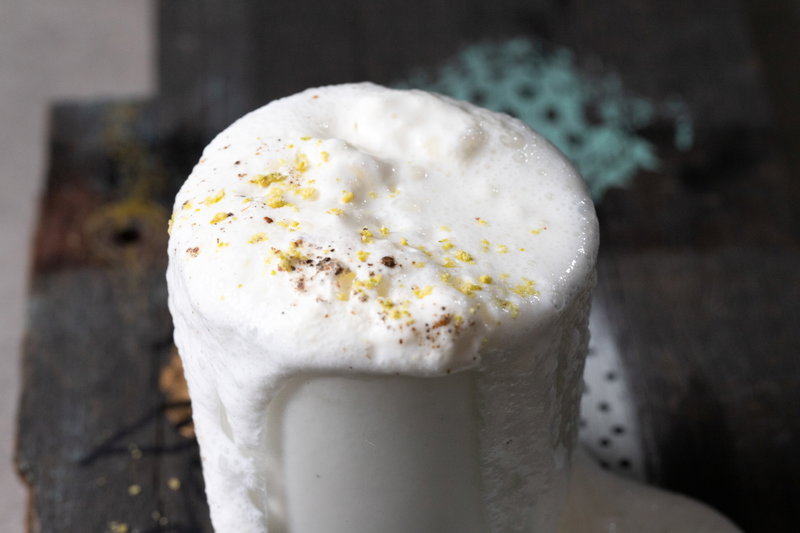 Sweet lassi overflowing from glass