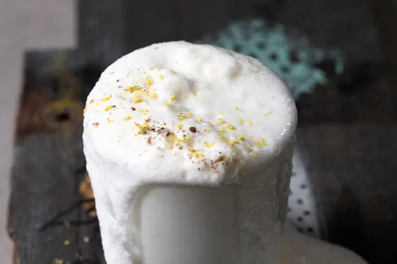 Sweet lassi overflowing from glass