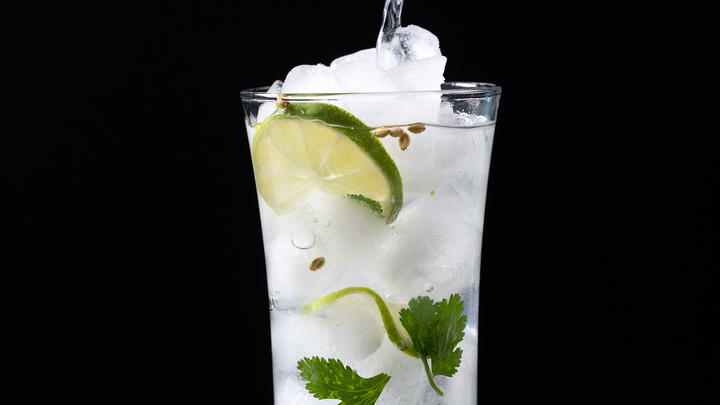 Pouring tonic into the cilantro gin and tonic