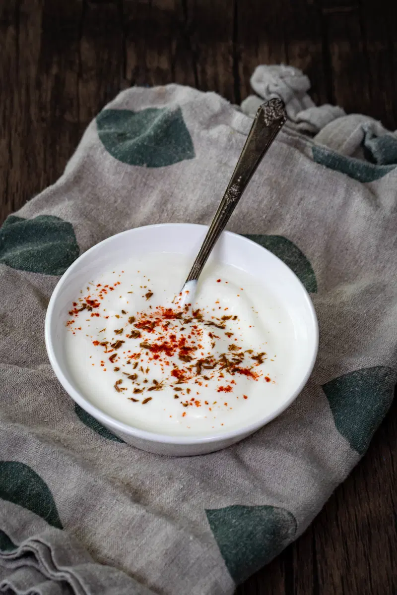 Dahi with a sprinkle of cumin, chili powder, and salt