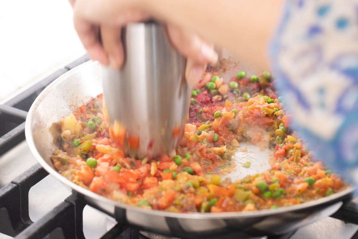 Mashing the vegetables (bhaji)