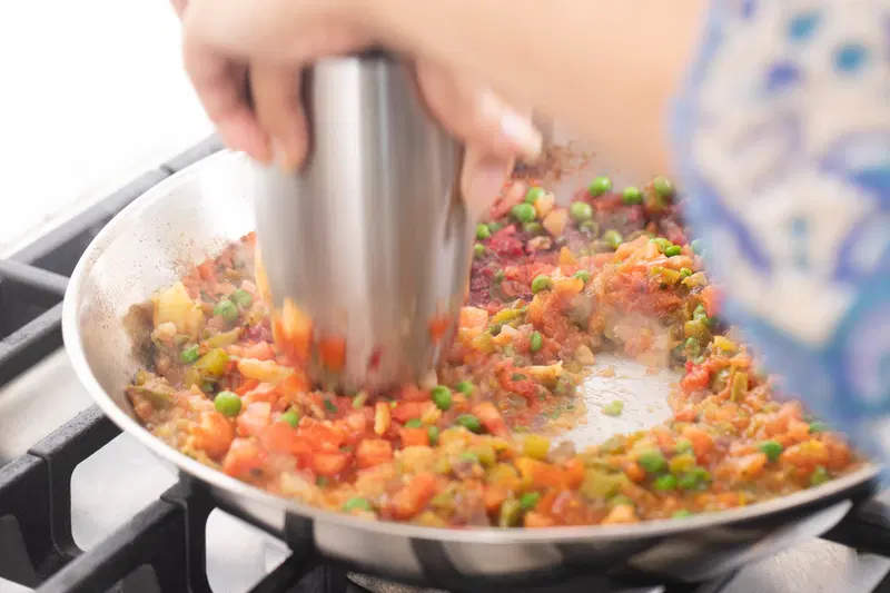 Mashing the vegetables (bhaji)