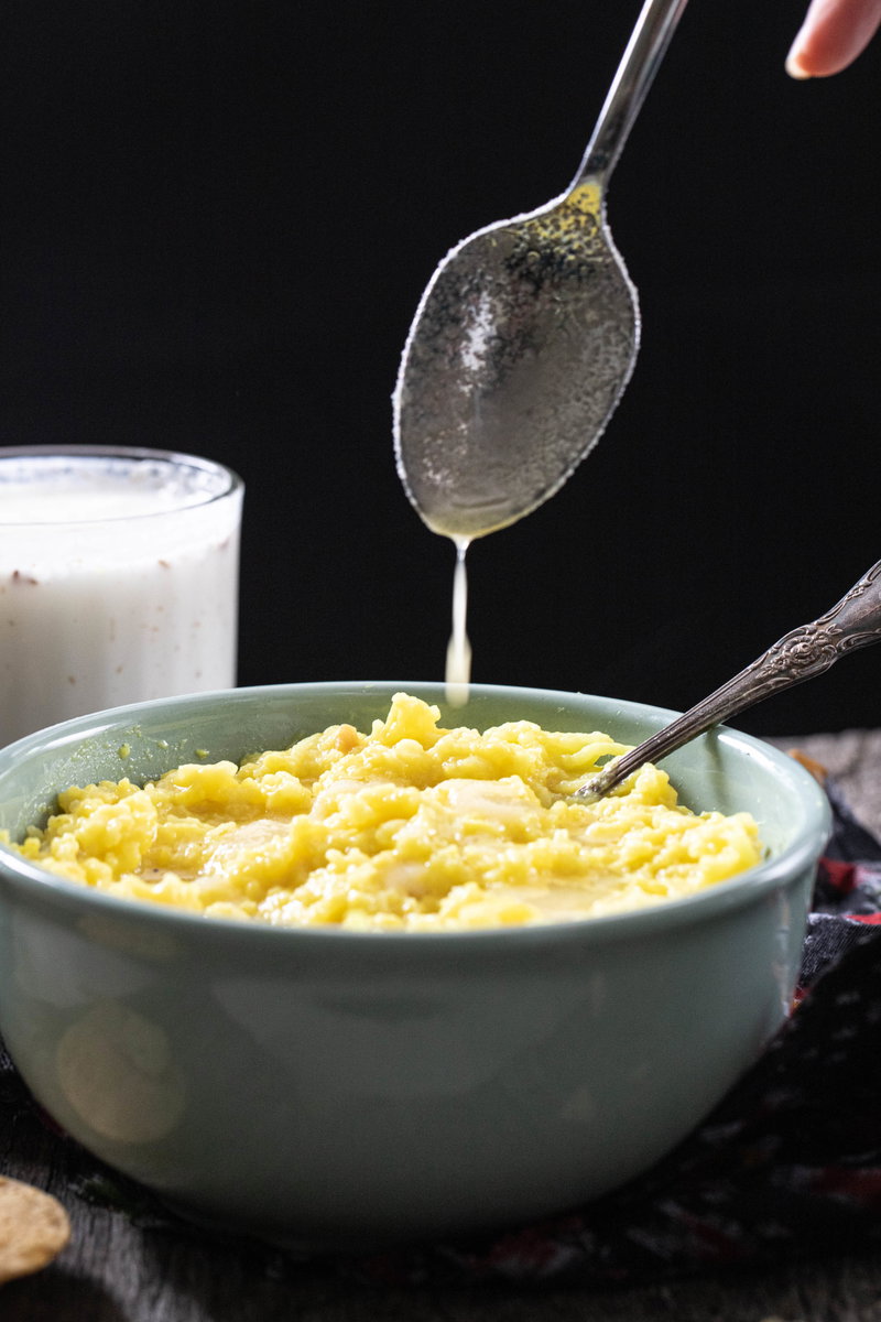 Drizzling ghee over khichdi.