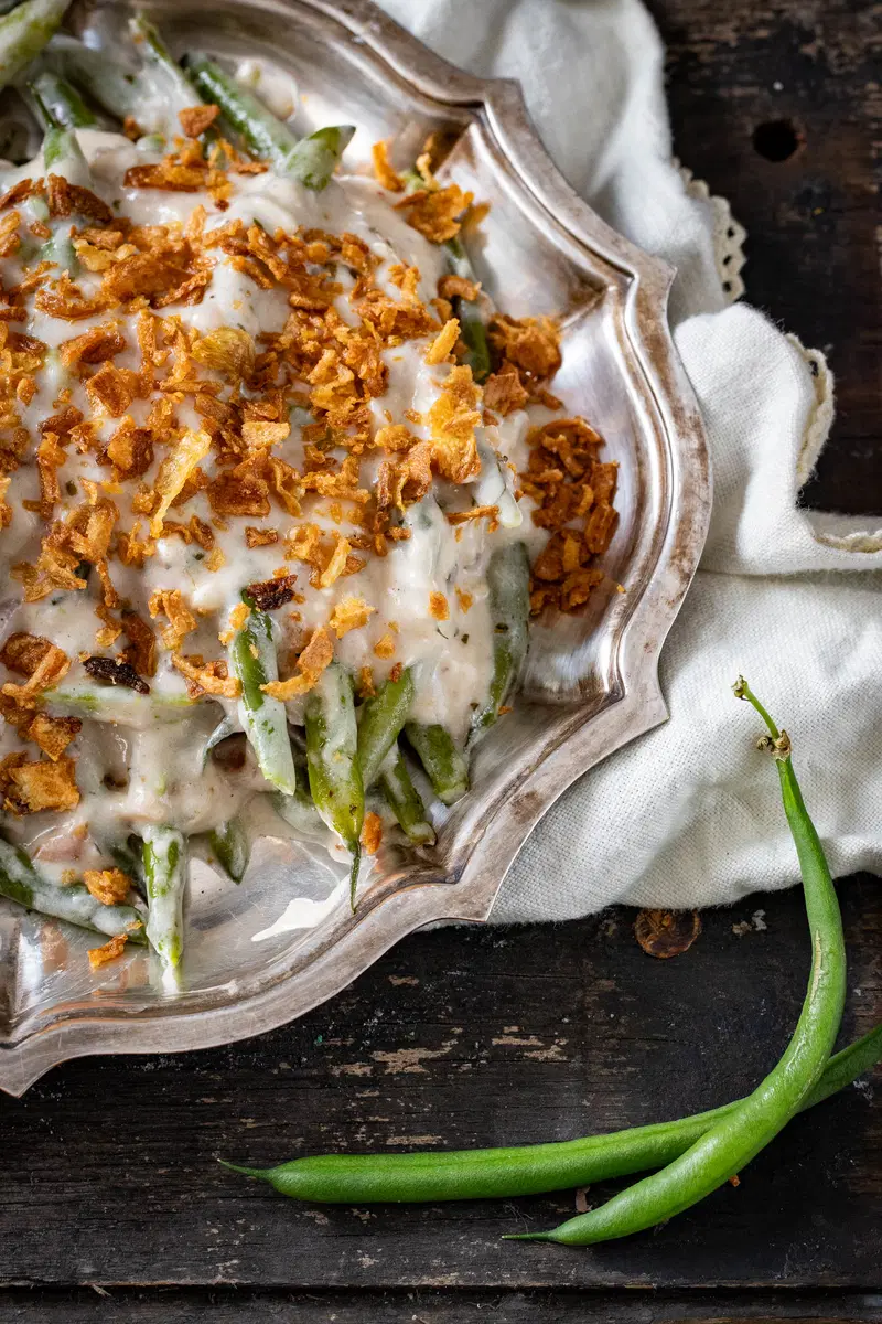 Methi malai green beans with fried onions on top