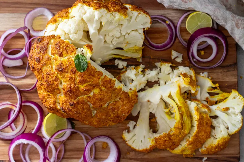Sliced whole roasted tandoori cauliflower