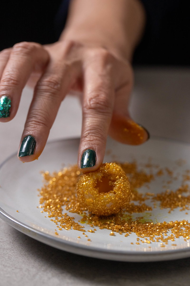 Coat the lychees in gold crystals.