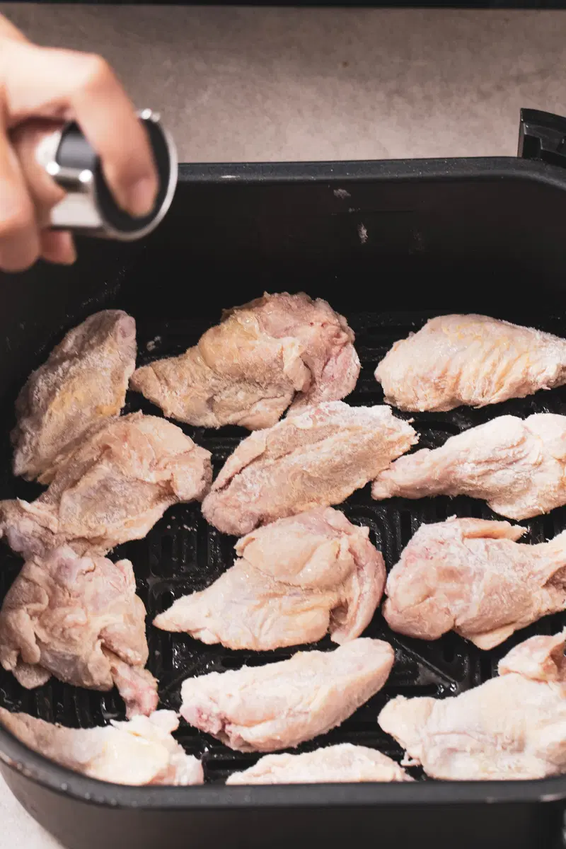 Coat the wings in oil and air fry.