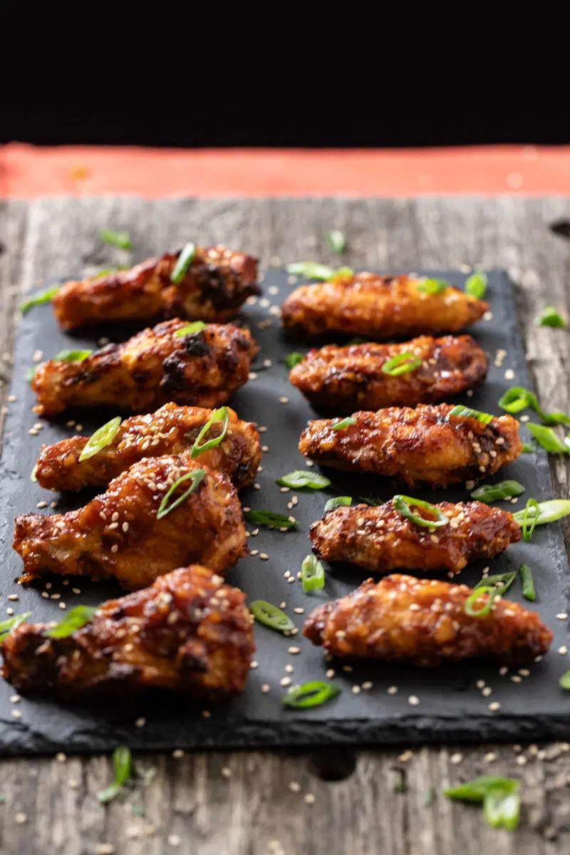 Soy garlic chicken wings on a slate slab.