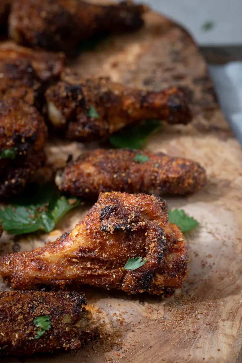 Chicken wings on a board.
