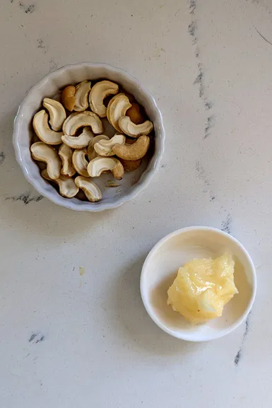 Add ghee and cashews.