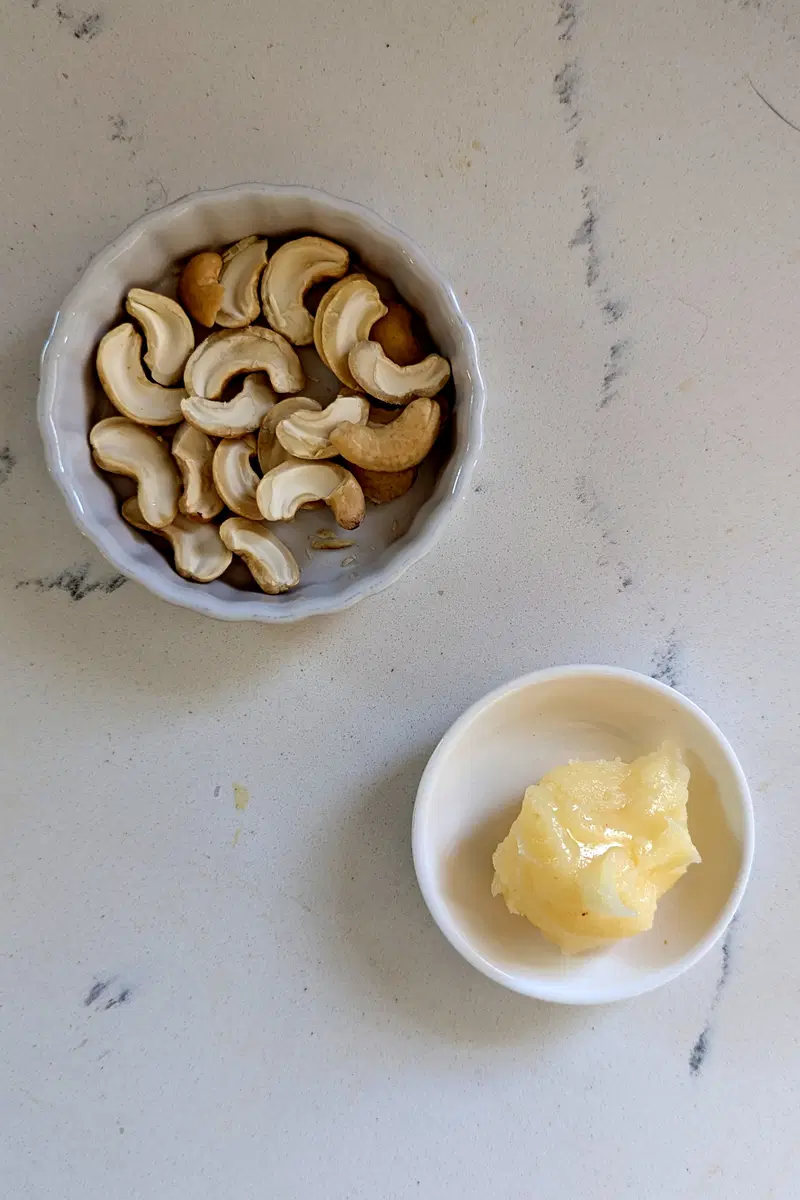 Add ghee and cashews.