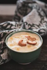 A bowl of payasam topped with cashews
