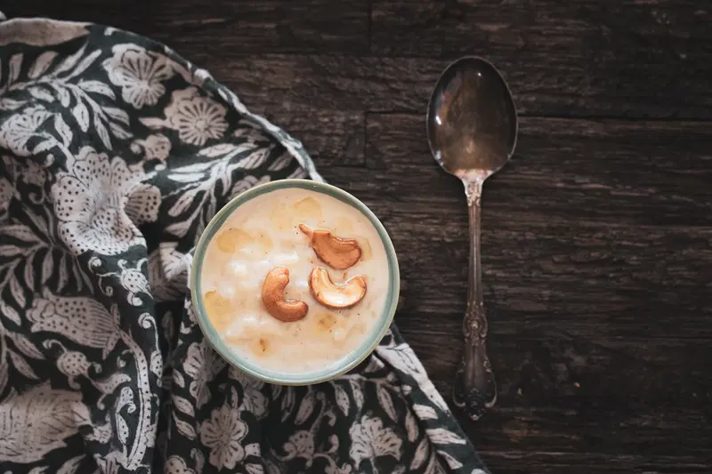 Payasam next to a spoon, ready to eat.