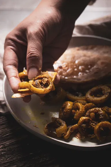 Getting read to eat snake gourd shaak with roti.