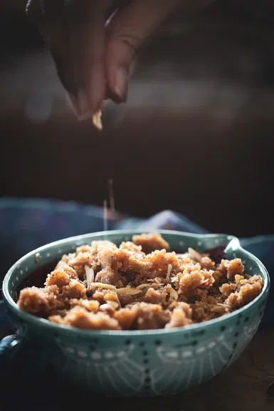 Garnishing the badam (almond) halwa with slivered almonds.