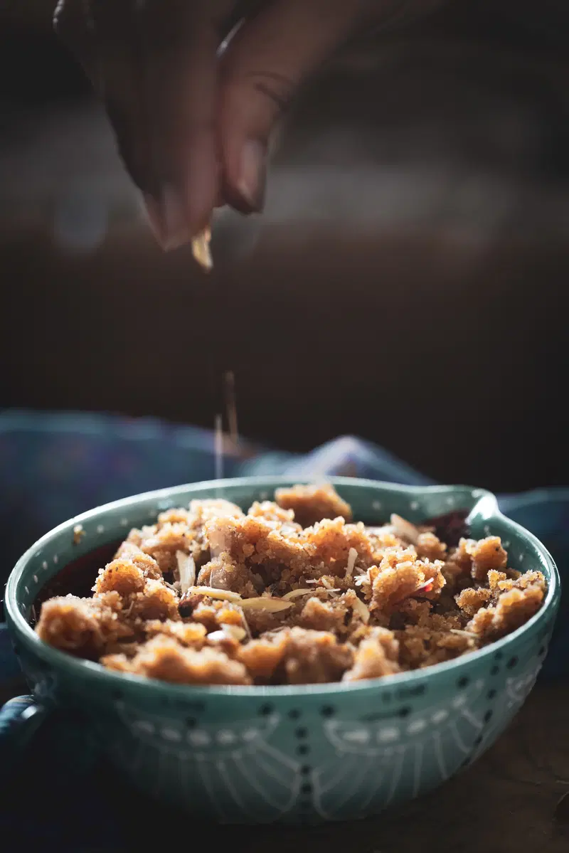 Garnishing the badam (almond) halwa with slivered almonds.