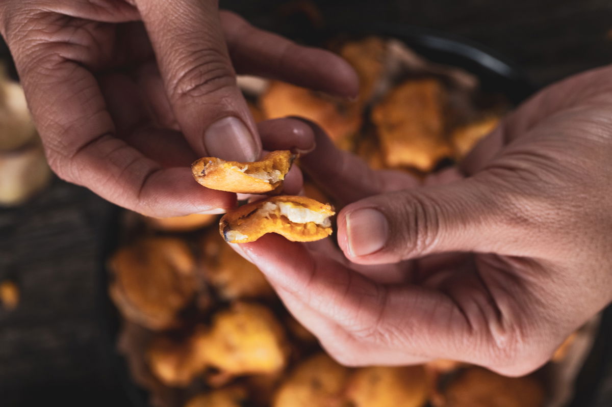 Splitting open an eggplant bhujiya.
