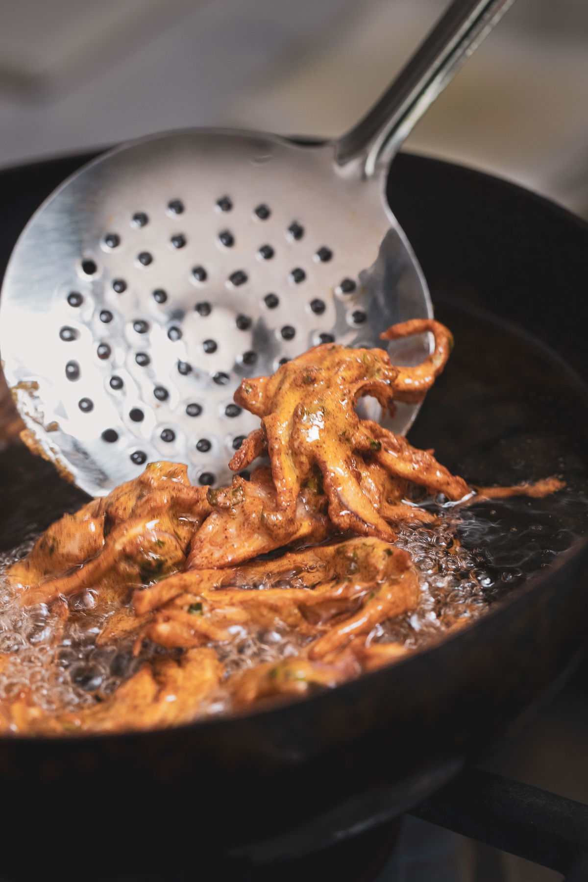 Deep frying the kanda bhaji.