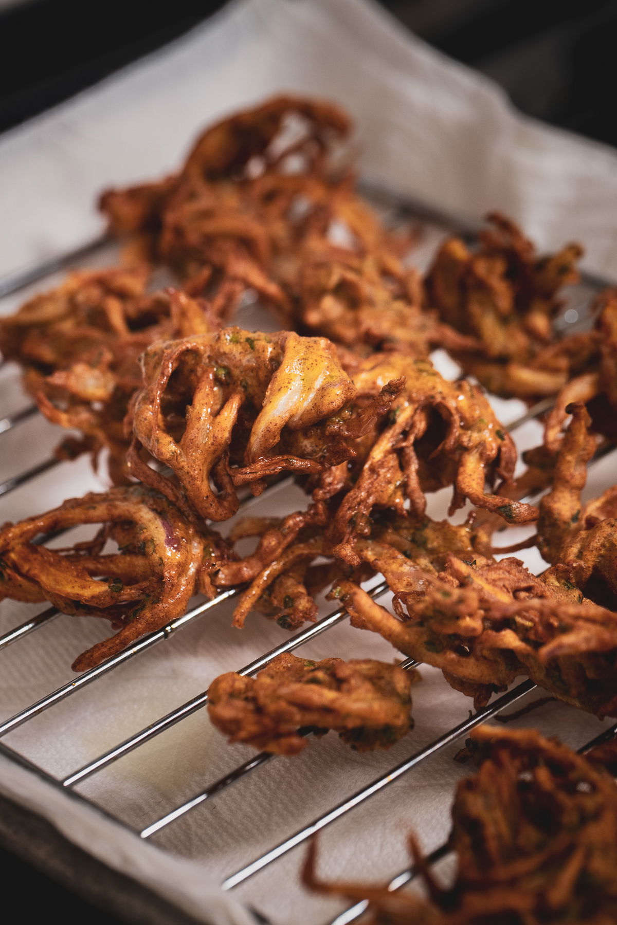Kanda bhaji on a cooling rack.