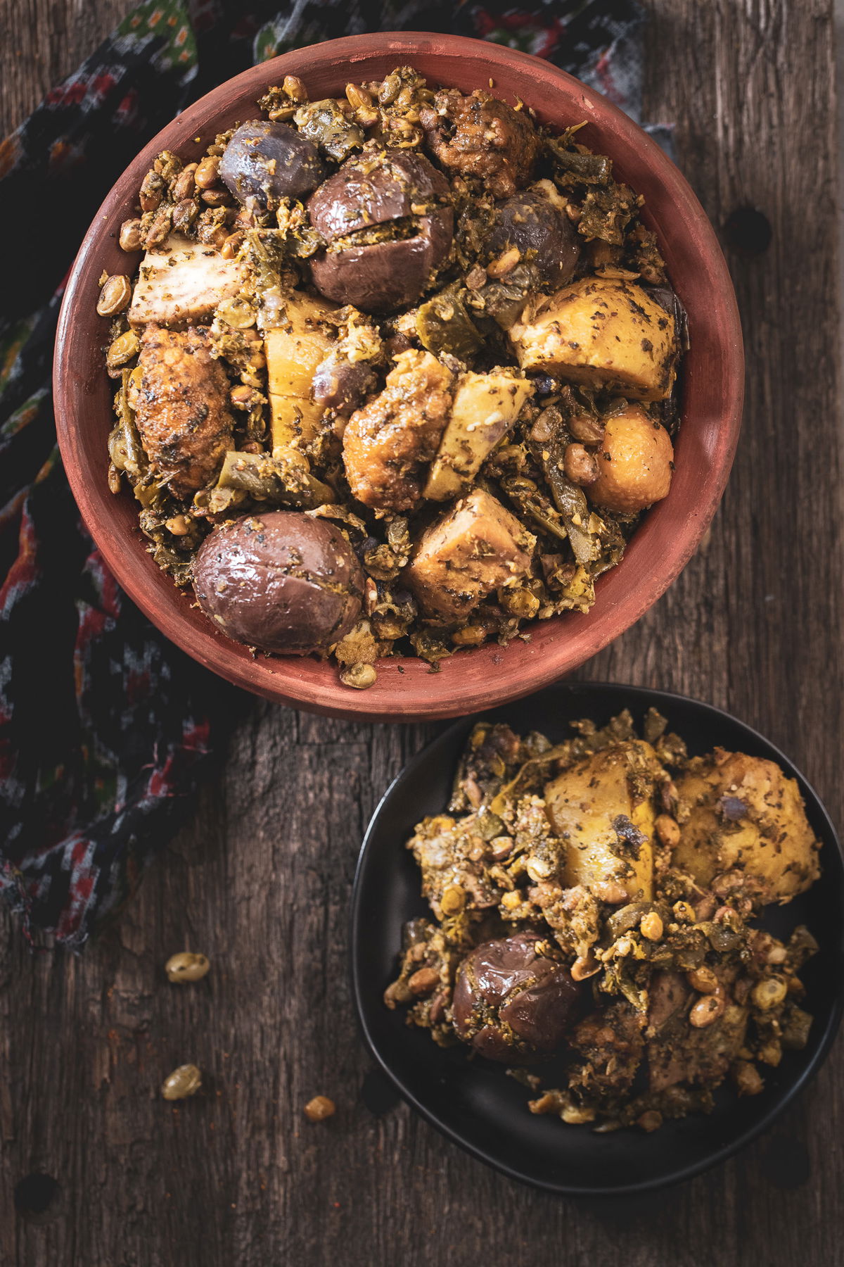 Top shot of Surti Undhiyu next to a serving on a plate.