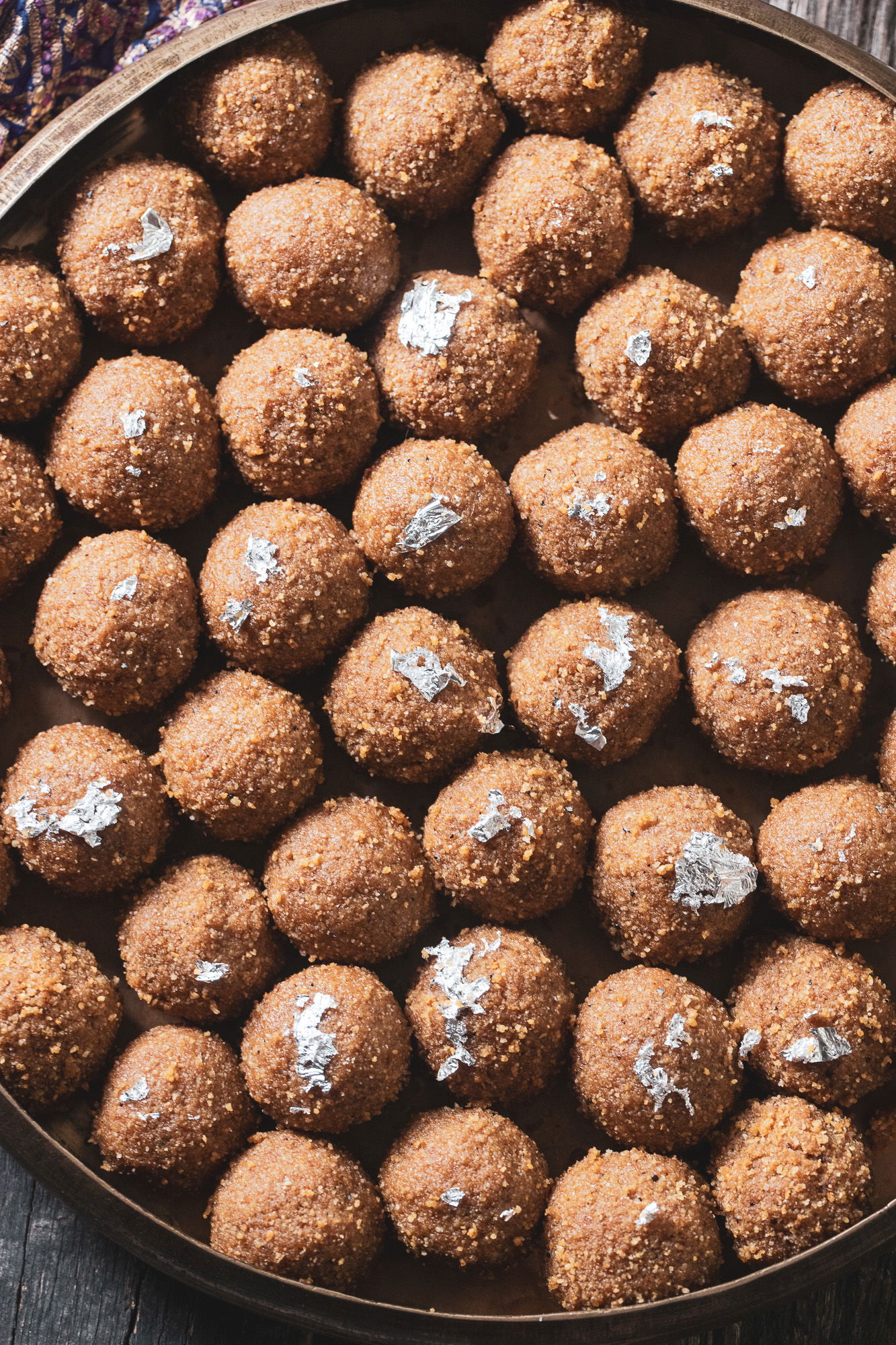 A dish filled with choorma ladoos.